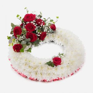 White wreath with red roses